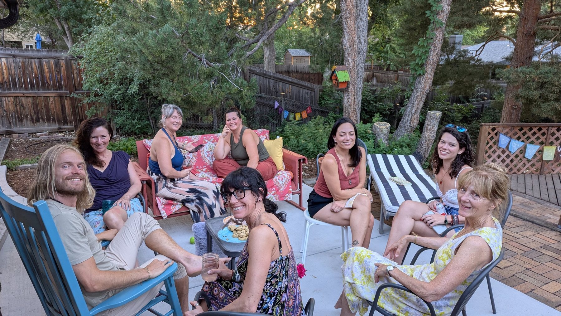 Team members relaxing together on a garden patio